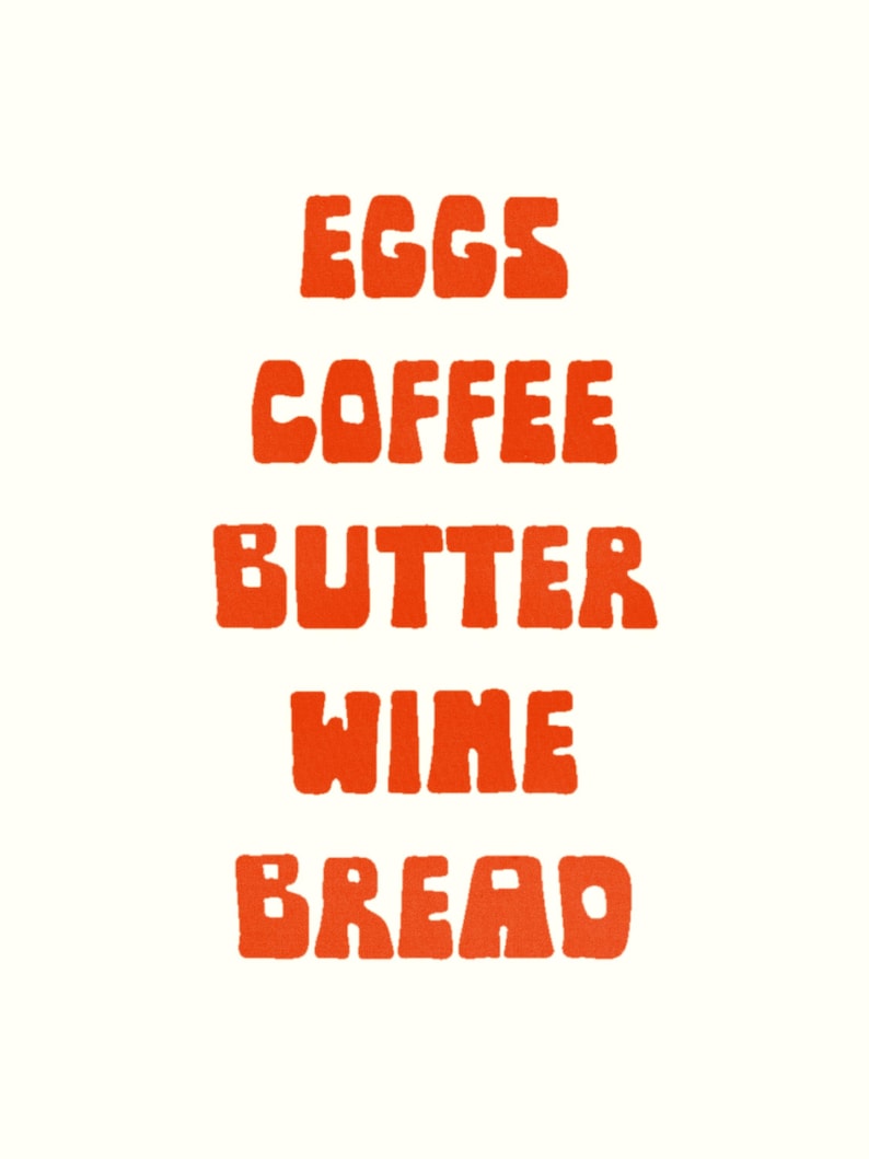 May include: A vertical graphic with the words "EGGS", "COFFEE", "BUTTER", "WINE", and "BREAD" in bold, orange letters. The words are stacked on top of each other against a cream-colored background.