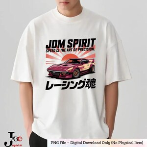 May include: White t-shirt featuring a graphic of a maroon and yellow sports car with the text "JDM SPIRIT" and "SPEED IS THE ART OF PRECISION." Japanese text is also included. The shirt is a digital download.