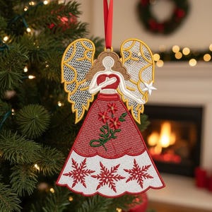 May include: Embroidered Christmas angel ornament with a red dress and white snowflake trim. The angel has gold wings and a star in one hand. The text "Christmas Angel" and "FSL Embroidery Design" are at the top.
