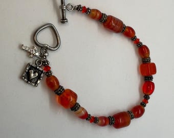 Orange glass and silver charm toggle clasp bracelet