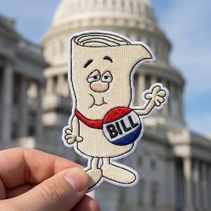 May include: Embroidered patch featuring a cartoon depiction of a bill, with a face and limbs. The bill is beige with a red sash and a blue and white circle that says "BILL". The background shows a government building.