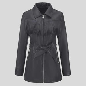May include: Black leather jacket with a collar, fringe detail across the chest, and a belt that ties at the waist. The jacket has a zipper closure and long sleeves. The jacket is a mid-length style.