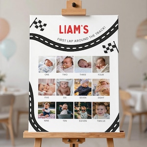 Könnte beinhalten: Leinwanddruck auf einer Staffelei mit Baby-Monatsfotos. Das Design zeigt ein Rennstreckenmotiv mit dem Text "LIAM'S FIRST LAP AROUND THE TRACK!" und Fotos mit den Bezeichnungen "ONE" bis "TWELVE". Schwarz-weiß karierte Flaggen sind ebenfalls vorhanden.