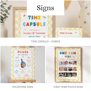 May include: A collection of three printed signs featuring a yellow and white checkered border and colorful text. The signs include a Time Capsule sign with matching cards, a My First Year milestone sign, and a One Fun Year photo collage sign.