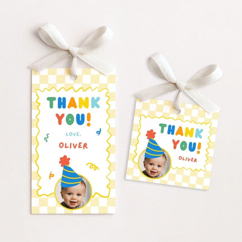 May include: Two rectangular gift tags with a yellow and white checkered pattern, topped with white ribbons. The tags feature the text THANK YOU! and LOVE, OLIVER in colorful letters, along with a circular photo of a baby wearing a party hat.