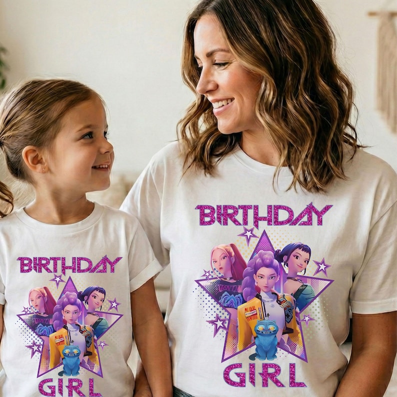 May include: White t-shirts with a colorful graphic design featuring the text "BIRTHDAY GIRL" and a group of animated characters inside a purple star. The shirts are worn by a mother and daughter.
