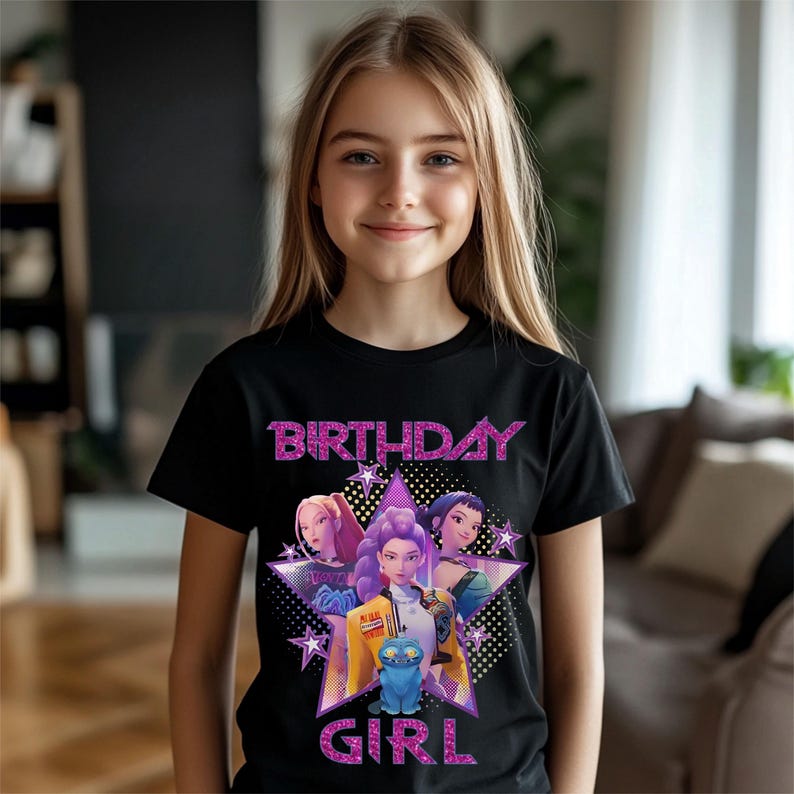 May include: Black t-shirt with a graphic of three animated girls and a blue cat inside a star. The words "BIRTHDAY GIRL" are in pink glitter lettering.