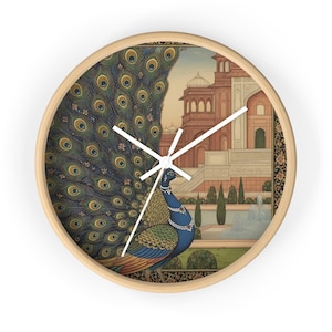 May include: Circular wall clock with a light wood frame. The clock face depicts a peacock with a detailed blue and green tail, set against an Indian palace and garden. The clock hands are white.