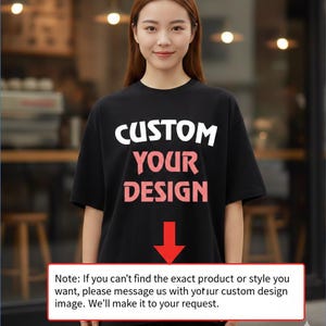 A woman wearing a black t-shirt with the text "CUSTOM YOUR DESIGN" printed on it, standing in front of a blurred background.