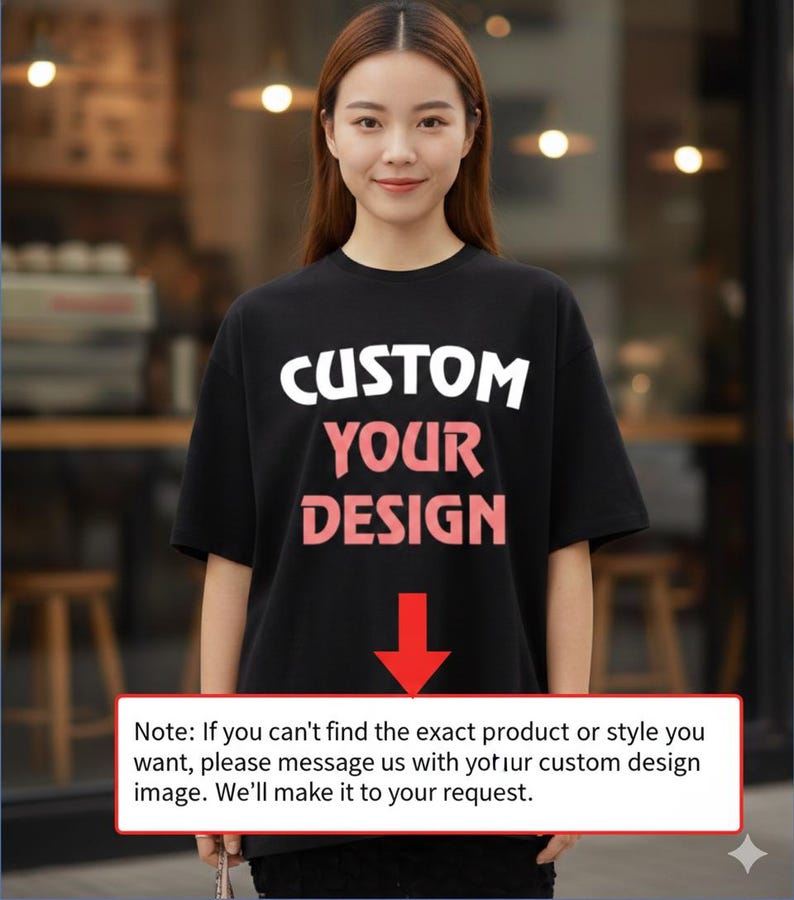 A woman wearing a black t-shirt with the text "CUSTOM YOUR DESIGN" printed on it, standing in front of a blurred background.