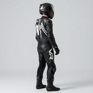 Right side view of men's black Venom Racing leather motorcycle suit showing spider back graphic VR branding spiderweb thigh panels knee armor and matching racing gloves and boots complete kit