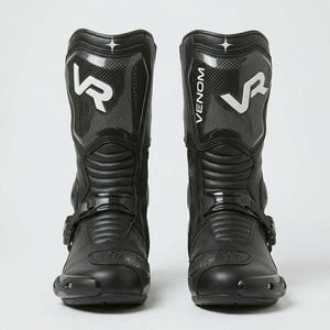 Front view of men's black tall leather motorcycle racing boots with VR Venom carbon fiber shin panel white branding and reinforced toe cap buckle closure