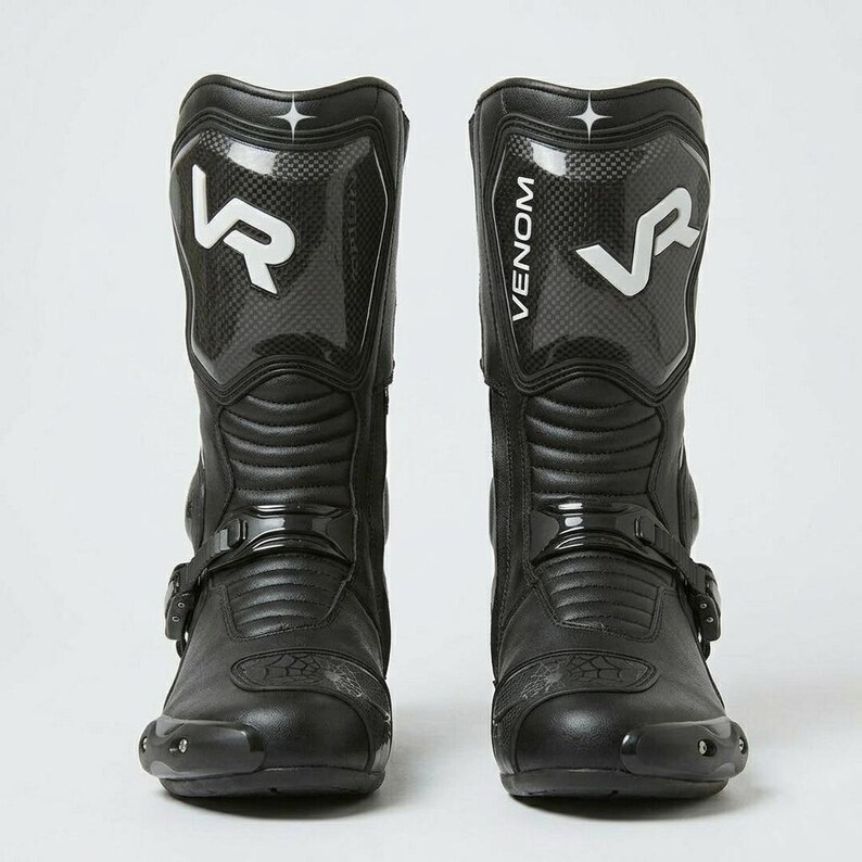 Front view of men's black tall leather motorcycle racing boots with VR Venom carbon fiber shin panel white branding and reinforced toe cap buckle closure