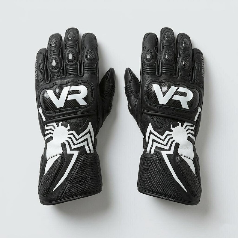 Men's black leather motorcycle racing gloves back view showing white spider graphic on wrist cuff and carbon fiber VR knuckle guard armor panel