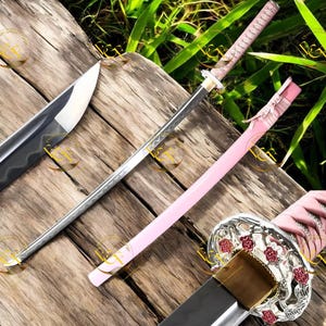 May include: A collection of decorative katana swords. One sword has a silver blade and a pink handle. Another sword has a black blade and a pink scabbard. The third sword has a silver blade and a pink handle with a decorative guard.