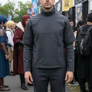 May include: A white ceramic mug with a black handle and the text "But First, Coffee" in a bold, black font. The mug is set against a blurred background, suggesting a cozy setting. The mug appears to be approximately 4 inches tall.