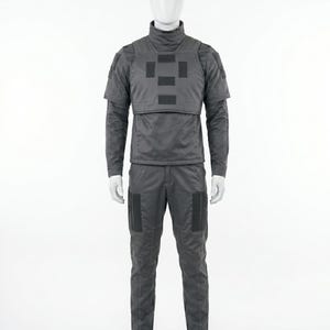 May include: A gray tactical uniform displayed on a mannequin. The outfit includes a long-sleeved shirt with a high collar, a vest with square patches, and matching pants. The uniform is designed for protection and features reinforced areas.