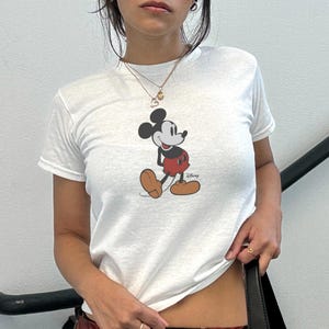 May include: A rustic wooden sign with the text "Welcome to our home" in white lettering. The sign features a distressed finish and a simple, inviting design, perfect for front door decor.