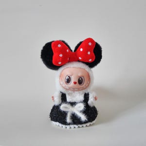 May include: A set of three ceramic mugs with a speckled, matte finish. The mugs are in shades of cream, light gray, and dark gray. Each mug has a simple, minimalist design, perfect for coffee or tea.