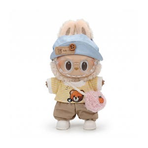 May include: White ceramic mug with a black handle, featuring the text "But First, Coffee" in black. The mug is displayed against a blurred backdrop, implying a comfortable environment.