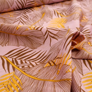Viscose fabric with leaves in pink, brown, and yellow - flowing fabric for dresses and blouses