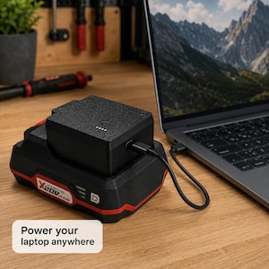 May include: A black Parkside X20V Team battery adapter connected to a laptop via a black USB-C cable. The rectangular battery unit features four white LED indicator lights on its top surface. The text "Power your laptop anywhere" is visible.