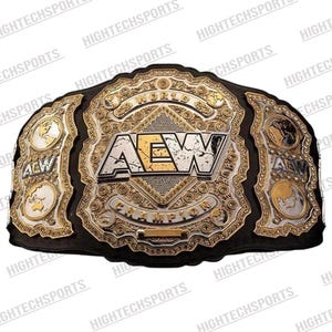 May include: A gold and silver AEW World Championship belt with a black leather strap. The belt features the AEW logo in the center, surrounded by intricate gold detailing and the word "Champion". The side plates display world maps.