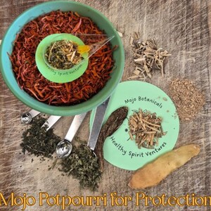 Può includere: Una ciotola turchese piena di pot-pourri arancione, un piccolo piatto verde con erbe e varie erbe e spezie sfuse. Il testo "Mojo Potpourri for Protection" è in basso.