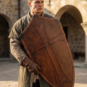 Leather-covered plywood templar shield with cross motif; crusader shield style, riveted edge for wall decor and medieval cosplay.