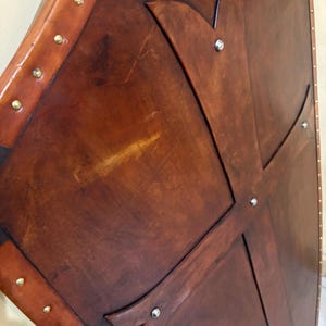 Leather-covered plywood templar shield with cross motif; crusader shield style, riveted edge for wall decor and medieval cosplay.