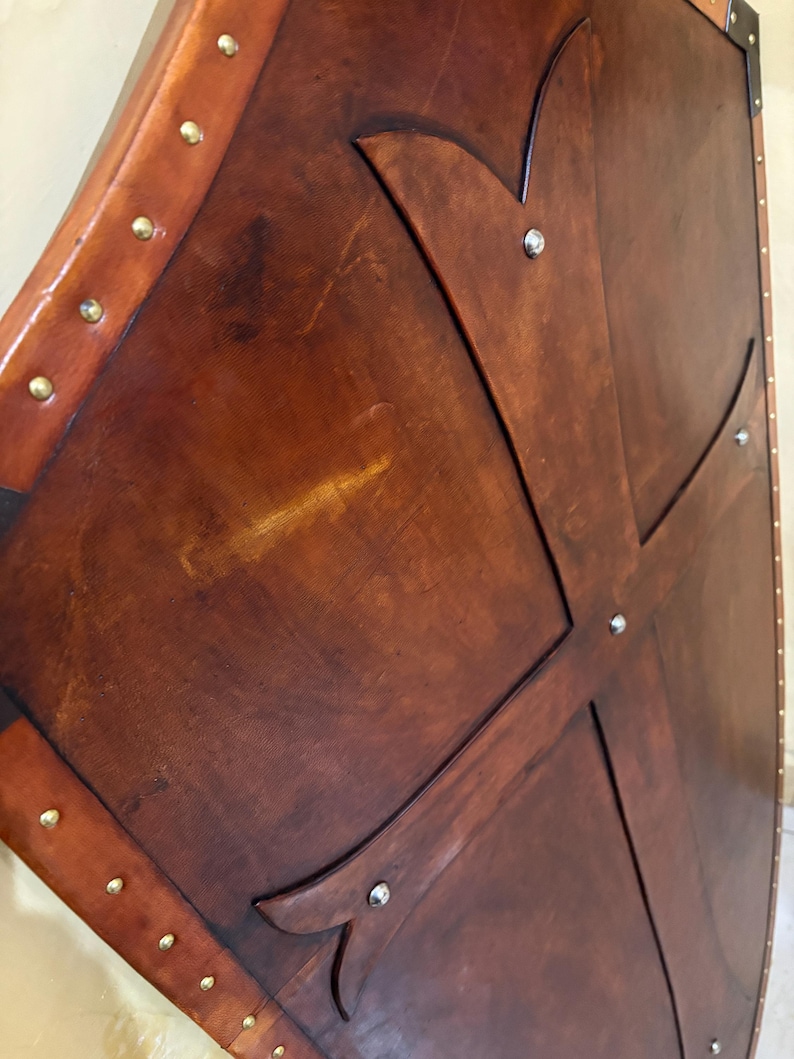 Leather-covered plywood templar shield with cross motif; crusader shield style, riveted edge for wall decor and medieval cosplay.