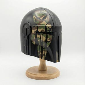 Hand-painted steel Mandalorian helmet in black with a bold red Mythosaur logo; cosplay armor style for fans.