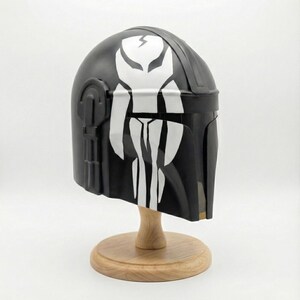 Hand-painted steel Mandalorian helmet in black with a bold red Mythosaur logo; cosplay armor style for fans.