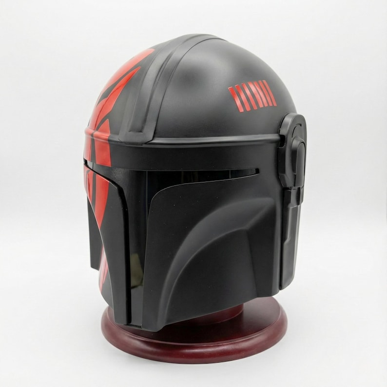 Hand-painted steel Mandalorian helmet in black with a bold red Mythosaur logo; cosplay armor style for fans.