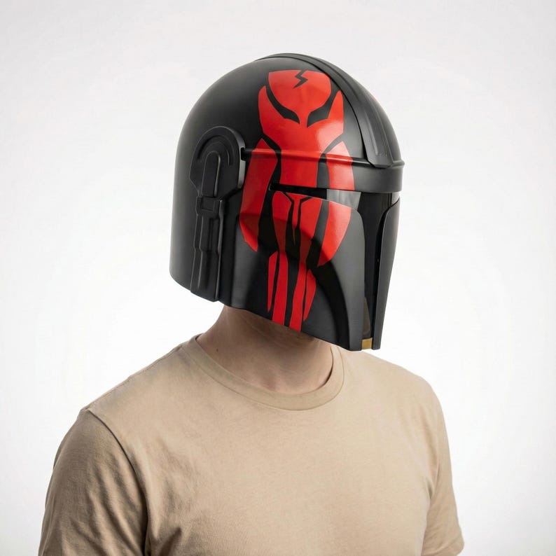 Hand-painted steel Mandalorian helmet in black with a bold red Mythosaur logo; cosplay armor style for fans.