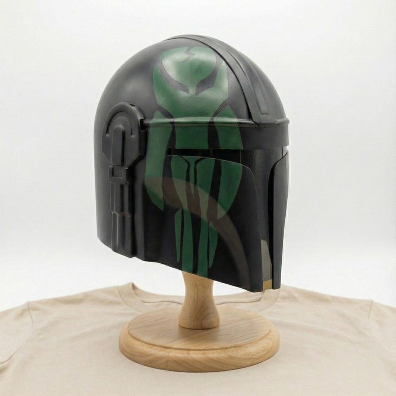 Hand-painted steel Mandalorian helmet in black with a bold red Mythosaur logo; cosplay armor style for fans.