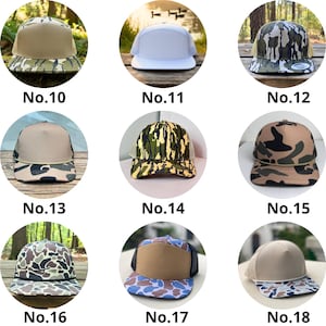 May include: A collection of trucker hats in various colors and camouflage patterns. Each hat features a mesh back and a flat brim. The hats are numbered from 10 to 18.