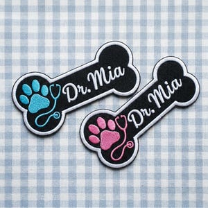 May include: A white ceramic mug with a black handle and the text "But First, Coffee" in a bold, black font. The mug is set against a neutral background, highlighting its simple design.