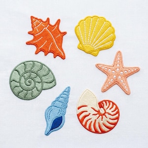May include: Embroidered patches of various seashells and a starfish in shades of orange, yellow, blue, green, and peach. The patches are on a white background. The seashell designs include a spiral, a conch, and a nautilus.