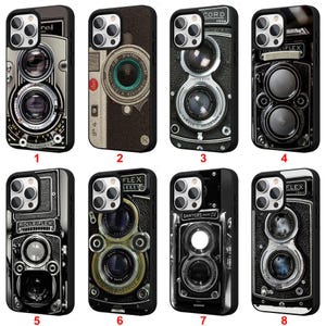 May include: A collection of eight phone cases featuring vintage camera designs. Each case showcases a different camera model, with detailed depictions of lenses, dials, and body textures. The cases are black with the camera designs in various shades of gray and brown.