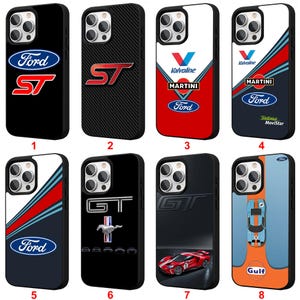 May include: A collection of eight phone cases featuring Ford logos and racing-inspired designs. The cases showcase the Ford ST, GT, and Gulf branding, with various color schemes including black, red, white, and blue. Each case is designed to fit a smartphone.