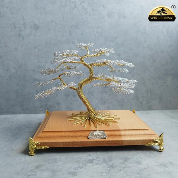 Luxury collection - wire bonsai trees in gold and silver colors on a  natural wooden base