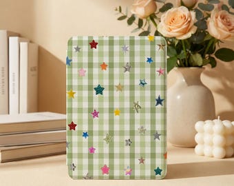 May include: A rectangular e-reader case featuring a light green and white gingham check pattern decorated with a scattered print of small, multi-colored stars in shades of red, blue, yellow, pink, and silver across the entire surface.