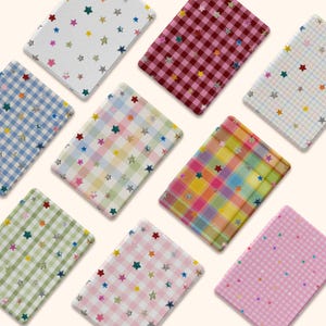 May include: A collection of eight rectangular cards featuring various patterns including gingham and plaid in colors like pink, blue, green, yellow, and red. Each card is decorated with small, scattered, multi-colored holographic star stickers.