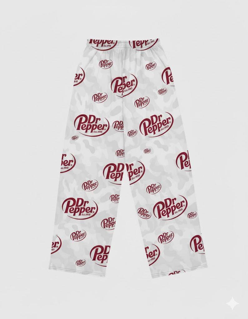 May include: White pajama pants with a repeating pattern of the Dr. Pepper logo in burgundy. The pants have a camouflage-style background with the Dr. Pepper logo scattered across the fabric.