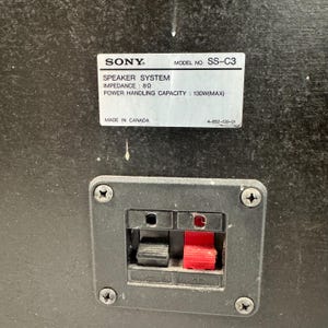 May include: Close-up of a black speaker component with a label that reads "SONY SPEAKER SYSTEM" and "MODEL NO. SS-C3". The label also indicates an impedance of 8&Omega; and a power handling capacity of 130W(MAX).