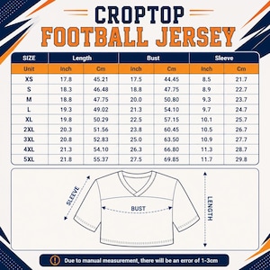 May include: A size chart for a croptop football jersey featuring a table with measurements in inches and centimeters for sizes XS through 5XL. Below the table is a line drawing of a V-neck jersey with arrows indicating the sleeve, bust, and length.