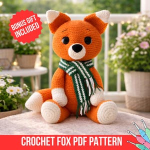 May include: A crocheted orange fox plush toy with white accents on the ears, paws, and tail. It wears a green and white striped scarf. The text "BONUS GIFT INCLUDED" is in a red circle. The text "CROCHET FOX PDF PATTERN" is at the bottom.