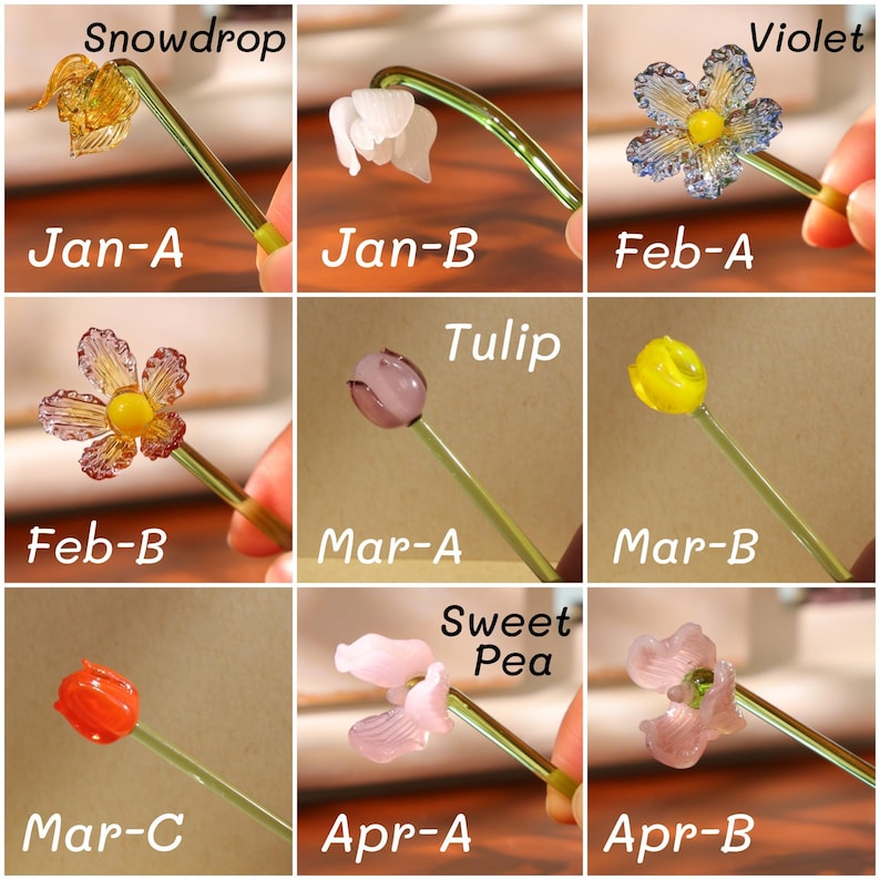 May include: A collection of glass flower sculptures, each with a different design and color, including a snowdrop, violet, and tulip. Each flower is attached to a green stem. The text "Snowdrop", "Violet", "Tulip", and "Sweet Pea" are visible.