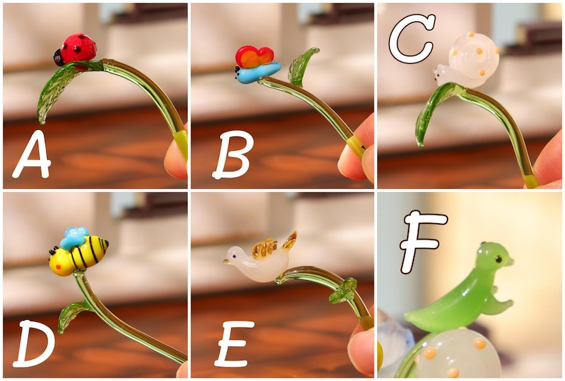 May include: A collection of miniature glass figurines, each depicting a different insect or animal perched on a curved glass stem with a leaf. The figurines include a ladybug, butterfly, snail, bee, bird, and a seal.